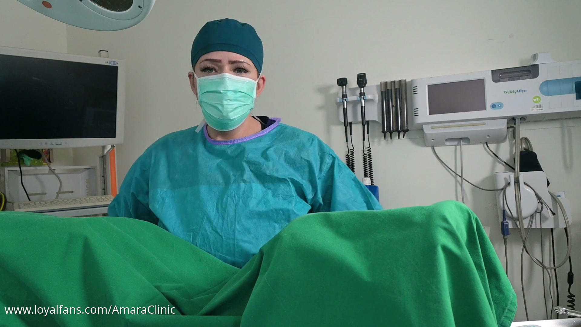 POV view of Mistress Katharina Amara prepping a patient for cystoscopy on her exam table in the free urology medfet video from Amara Fetish Clinic Belgium